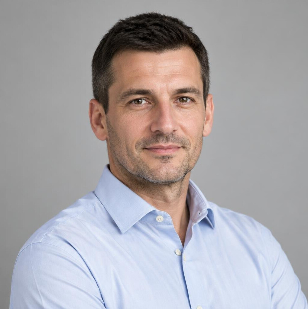 Portrait of a man in a light shirt looking at the camera