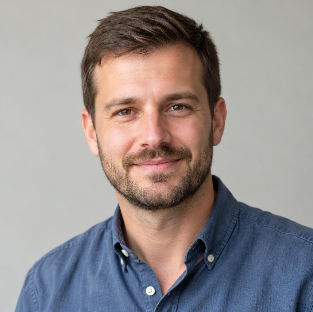 Portrait of a smiling man with short hair and a beard